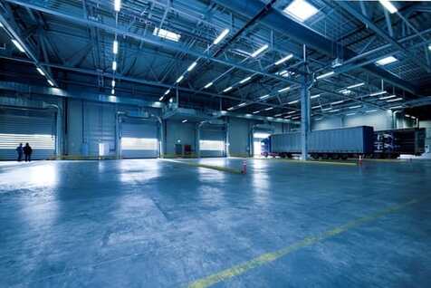 Picture of a large warehouse with polished concrete and industrial lighting on the ceilings